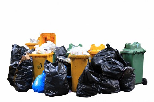 Skip truck delivering waste container in Yeading