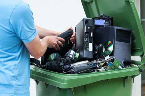 Residents loading waste into a skip